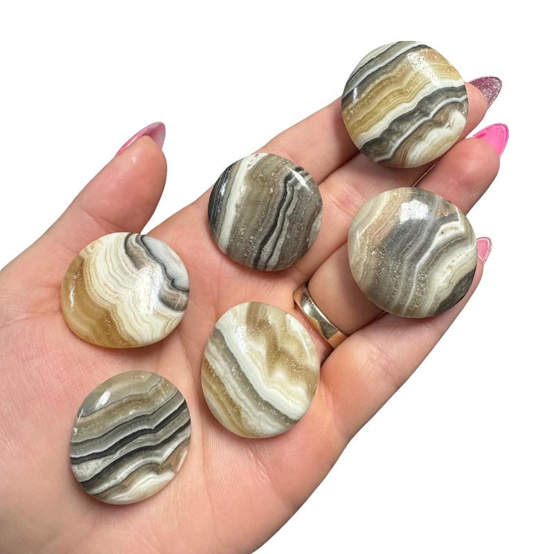 "Empower Your Energy: Natural Crystal Worry Stone 💎🌙"  This gemstone coin pocket stone helps promote healing and focus, making it the perfect mini accessory for peace and balance on the go. 🌸✨