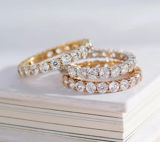 "Infinite Sparkle: Diamonique 100-Facet Eternity Ring 💎🌟"  With 100 brilliant facets, this eternity band ring features the stunning clarity of Diamonique, available in 14K Clad or Sterling, making it a symbol of everlasting beauty. 💖💍