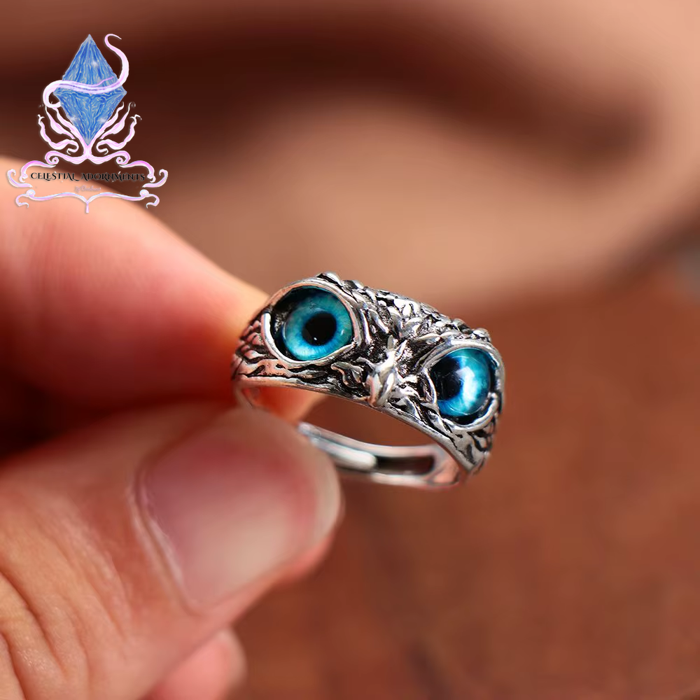 "Enchanting Owl: Colorful Cat Eye Gothic Ring 🦉✨"  A perfect blend of mysticism and style, this adjustable owl ring with a colorful cat-eye stone is a unique and trendy piece for both men and women. 💖💎