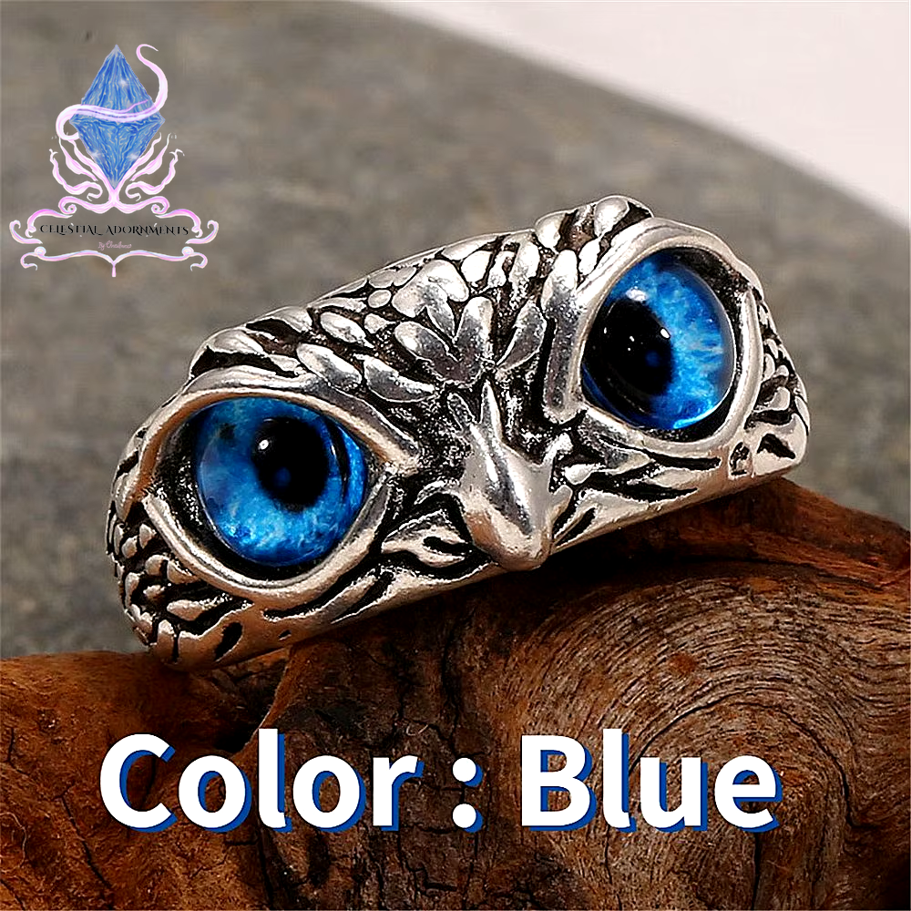 "Enchanting Owl: Colorful Cat Eye Gothic Ring 🦉✨"  A perfect blend of mysticism and style, this adjustable owl ring with a colorful cat-eye stone is a unique and trendy piece for both men and women. 💖💎